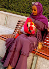 WOMEN LADIES SITTING ON BENCH SEAT IN DUBAI IN BURGUNDY RED ELEGANT FASHION ABAYA DRESS ISLAMIC DRESS HIJAB VEIL COVER MODESTY CLOTHING