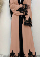 WOMAN WEARING PINK AND BLACK ABAYA 2025