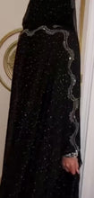 Black sparkly abaya with shimmering details, perfect for evening wear and formal occasions